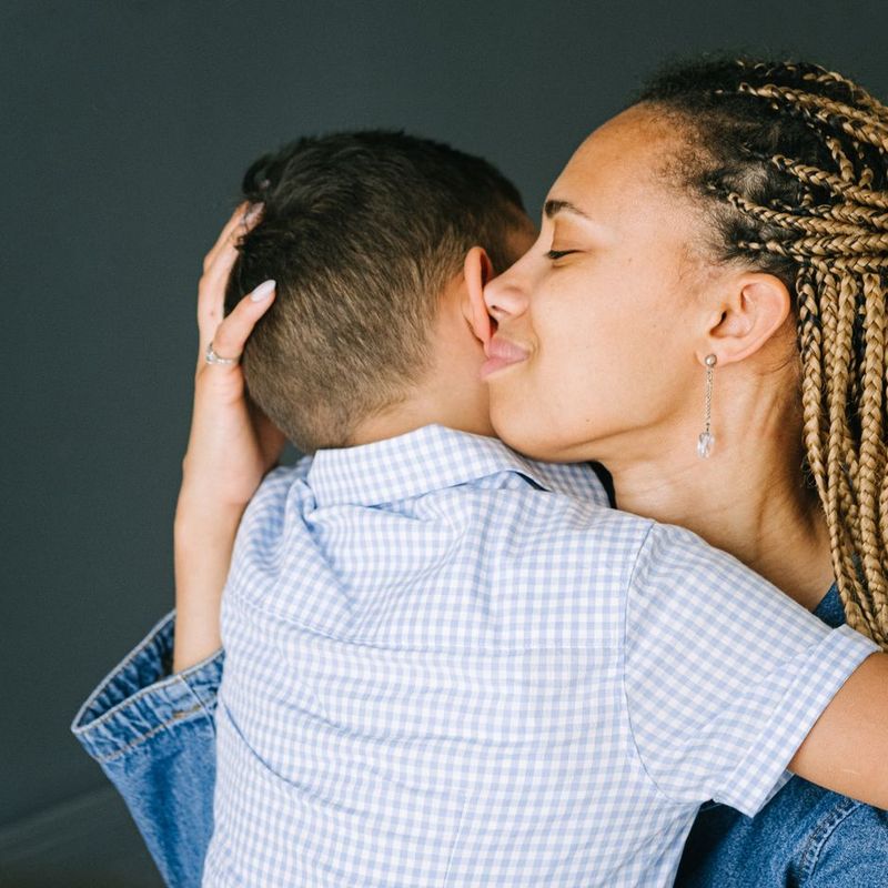 Mãe abraçando e beijando o filho